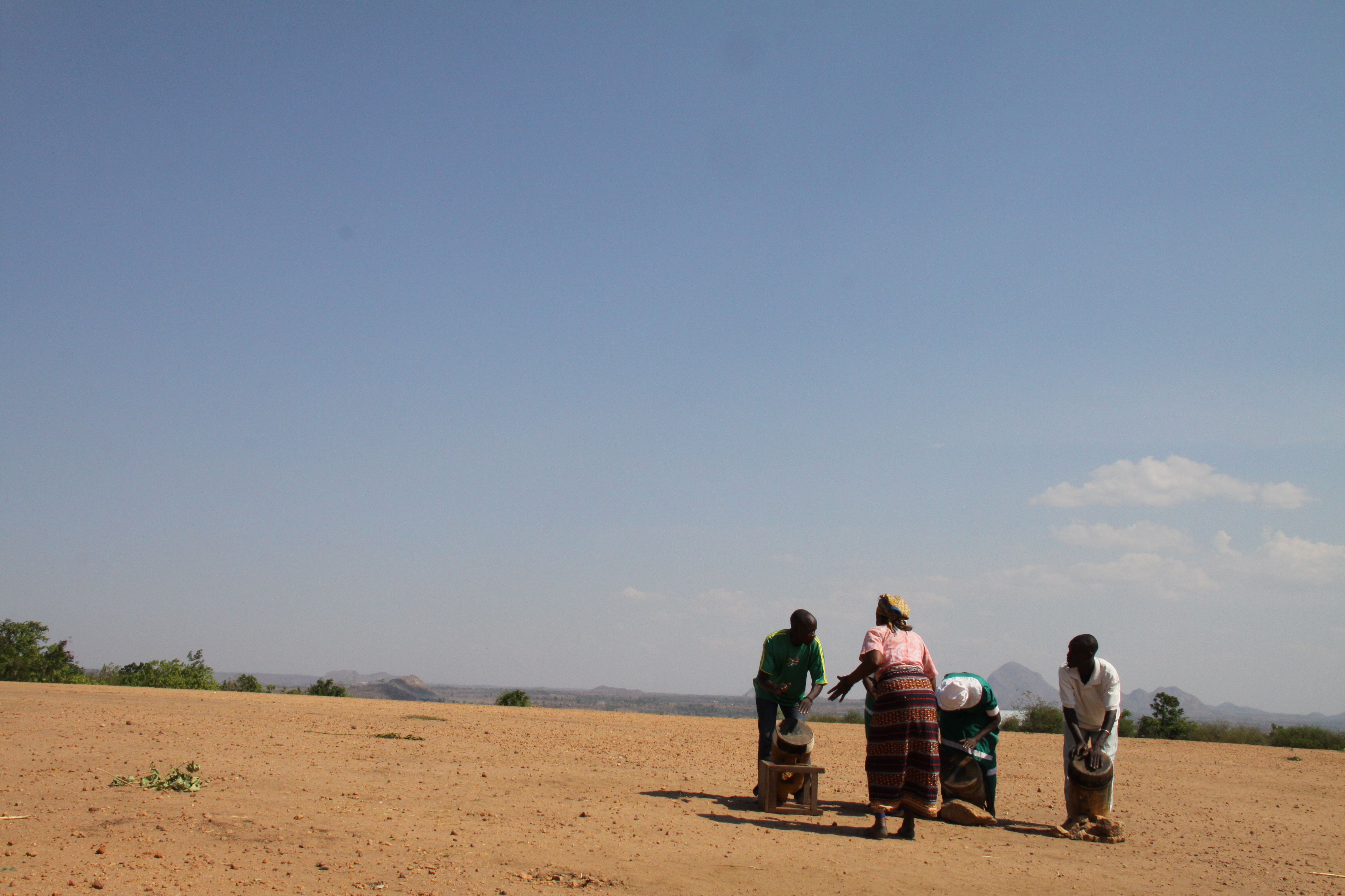 Drummers and a singer perform against the backdrop of the beautiful, dry Malawian countryside. Photograph by Ingrid Ytre-Arne.