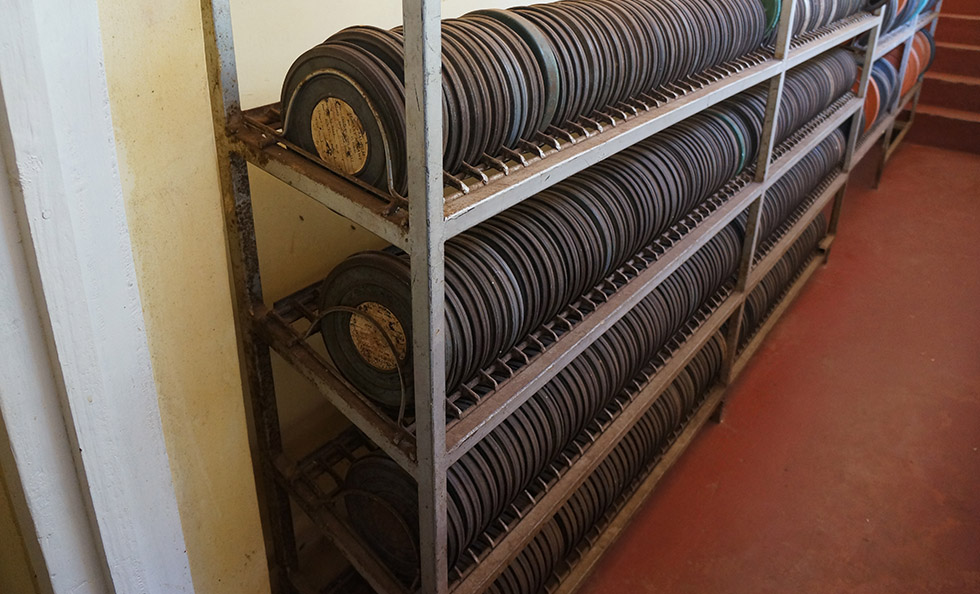 Slider Image Shelves of film reels awaiting digitisation and cataloguing.